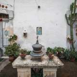 ...preceduto da un tavolino in pietra originale sul quale sono posati una campana di ferro e due vasetti. �� la d�pandance � spiega Lorusso �, realizzata anche questa nel 1896 per trovare una sistemazione al contadino che avrebbe lavorato per la villa e a tutta la sua famiglia: gli Sforza�